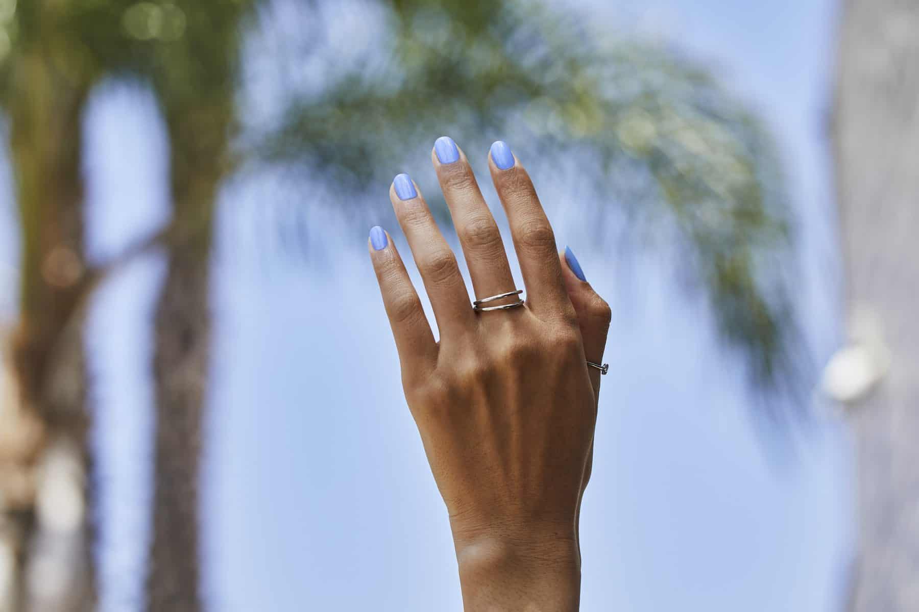 A hand with painted nails in the "Can’t CTRL Me" shade from the Palette Xbox collection from OPI