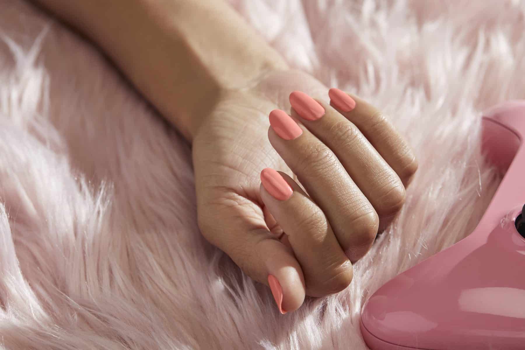 A hand with painted nails in the "Suzi is My Avatar" shade from the Palette Xbox collection from OPI