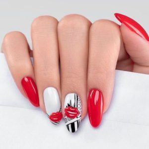 Red nail polish along with white and black nail art, and red lips