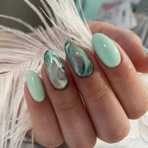 A vibrant nail design on a light blue nail polish