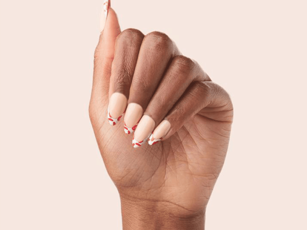 Hand shot with light pink nail polish