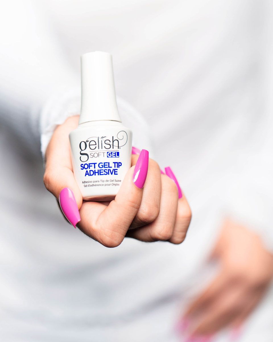 Soft Gel Adhesive Bottle and Pink manicure hand shot