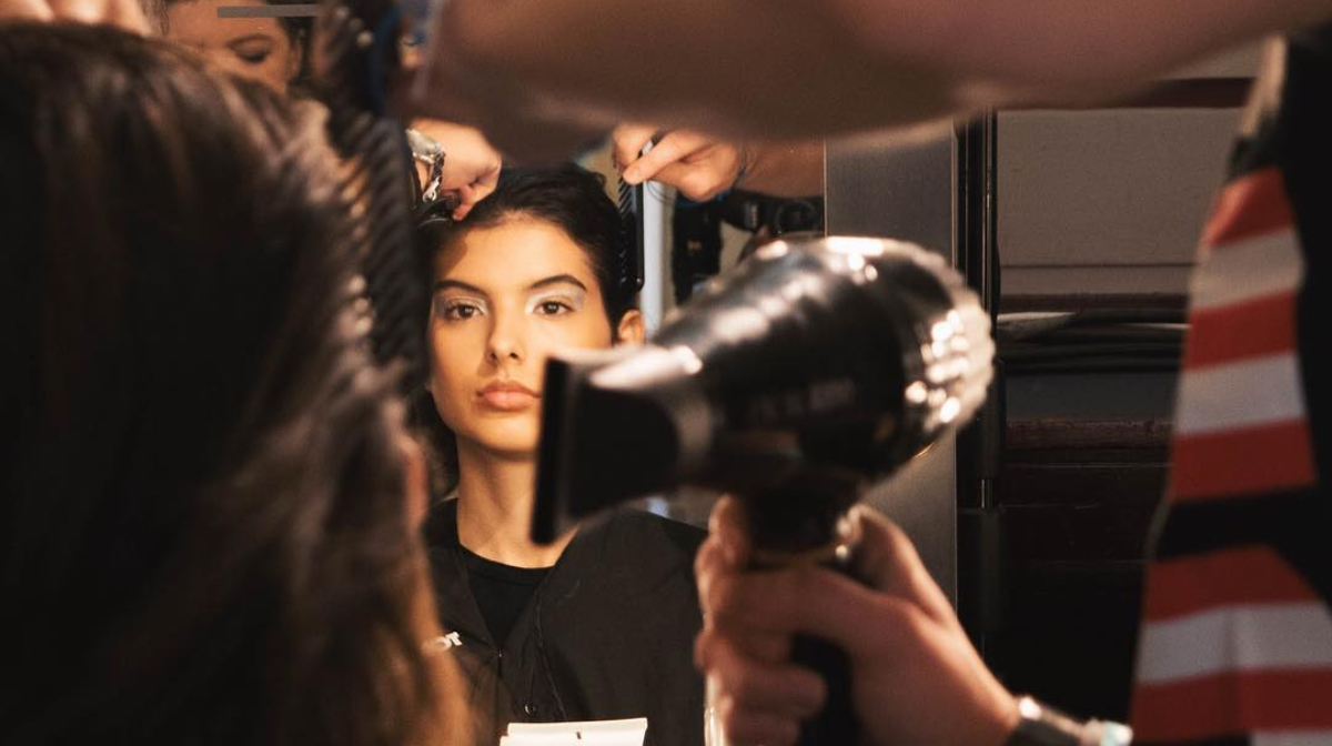 A BaBylissPRO hairdryer is used to style a model's hair