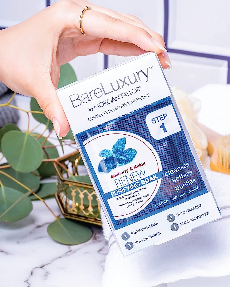 A woman's hand hold the BareLuxury RENEW Product, the Goji Berry & Kukui fragrance