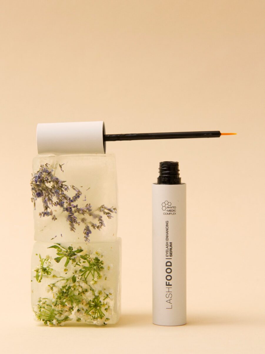 The LashFood Serum Enhancer from JB Lashes on a beige background