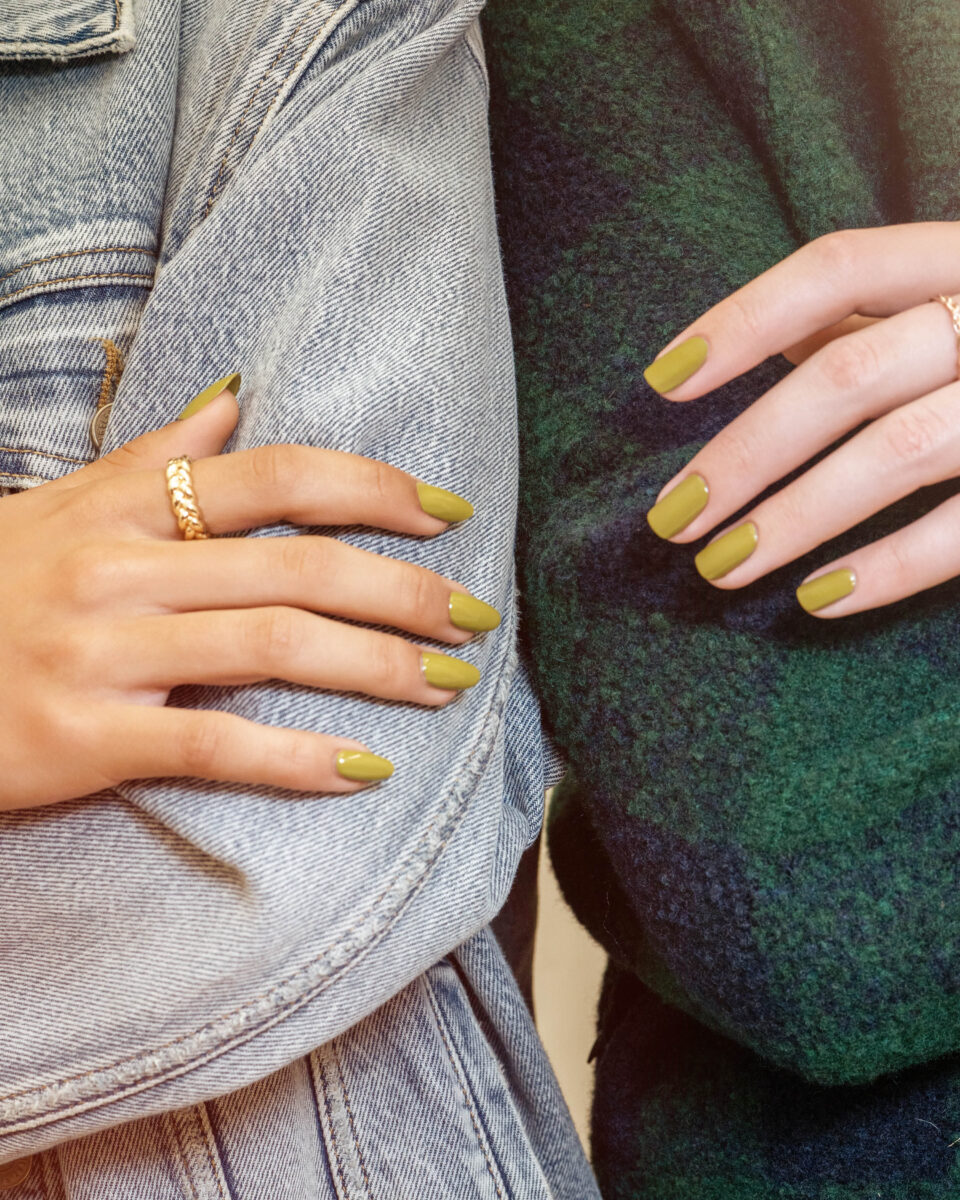 Two faceless women standing be side each other with nails painted in rosy mauve using one of the Change Of Pace collection shades from Gelish for Fall 2023