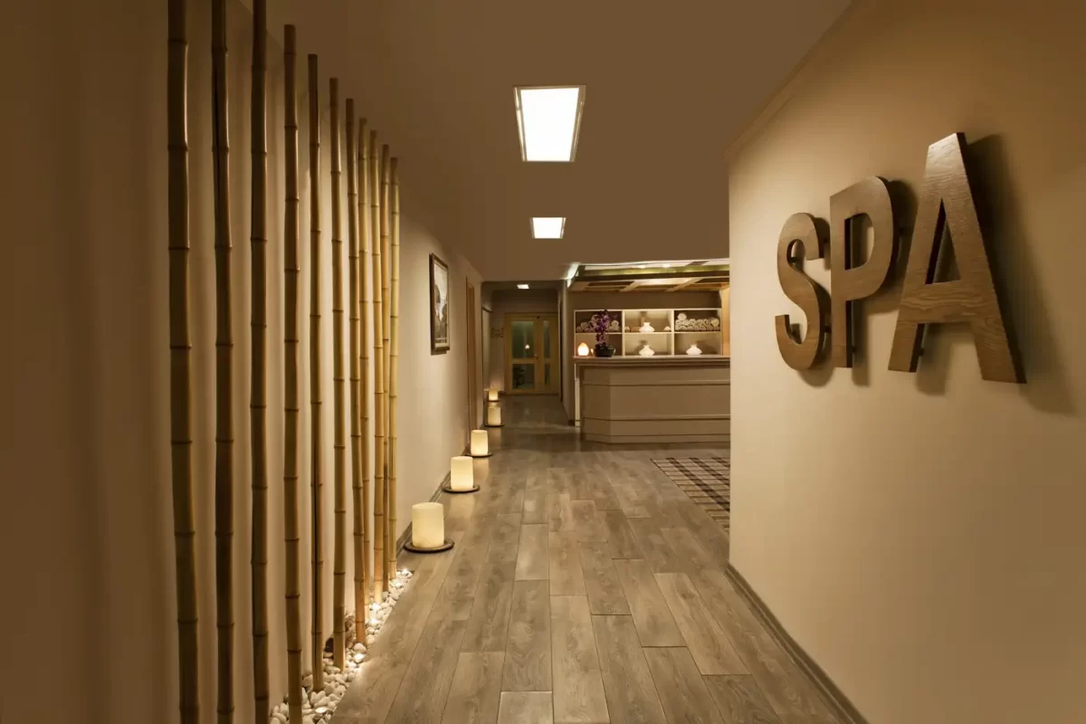 A hallway with bamboo poles and a sign that says Spa.