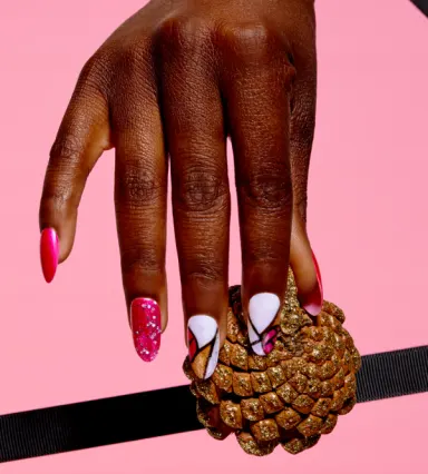 A girl's nails painted with Better Not Pout, Glittery color-blocked french tips that are so rougie.