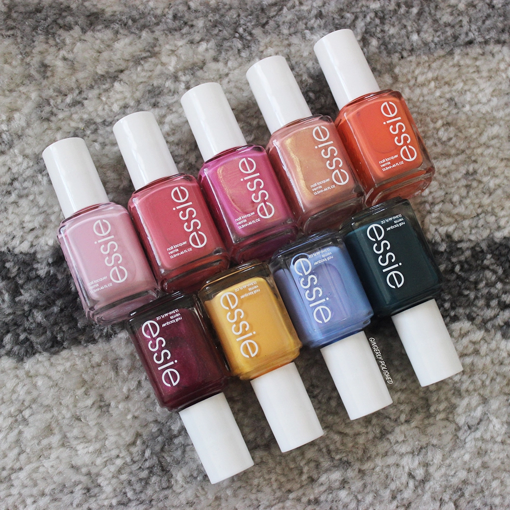 Different Essie traditional nail polish on a gray rock. Light pink, purple, yellow, bold green, light blue, orange and burgundy shades