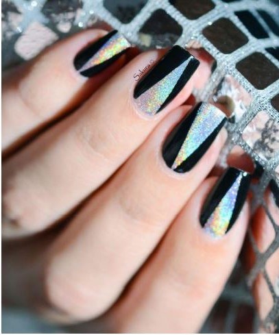 Female hand with beautiful holiday manicure - silver glittered nails with Christmas twisted wire with stars. Selective focus. Closeup view.