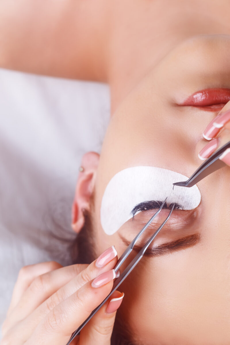 Eyelash Extension Procedure. Woman Eye with Long Eyelashes. Lashes. Close up, macro, selective focus