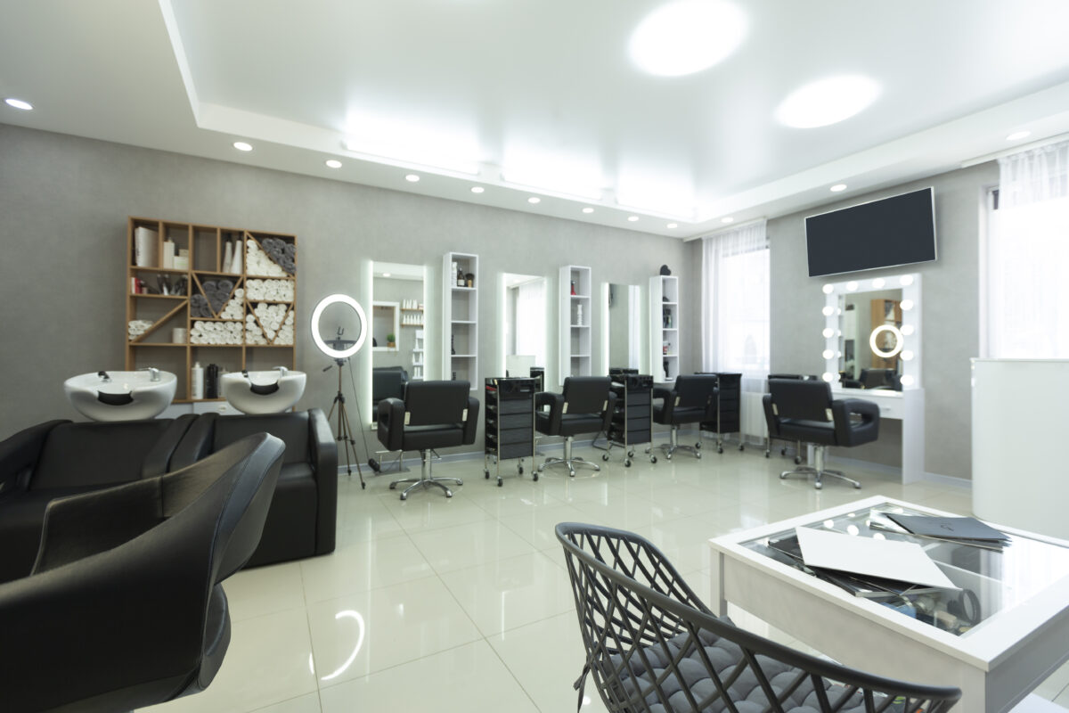 Interior of modern hair salon with barber armchair, free space