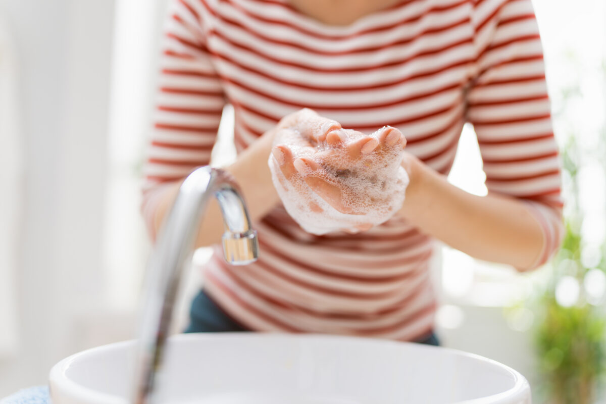 Person is washing hands rubbing with soap. Protection against coronavirus. Prevention, hygiene to stop spreading virus.