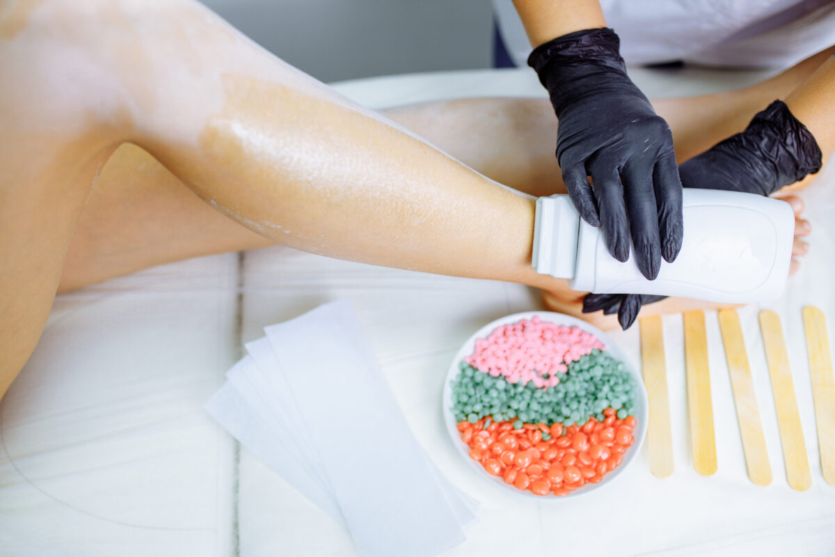 Sugaring: woman at cosmetics salon waxing legs. Satin Smooth Educational Videos, Youtube channel