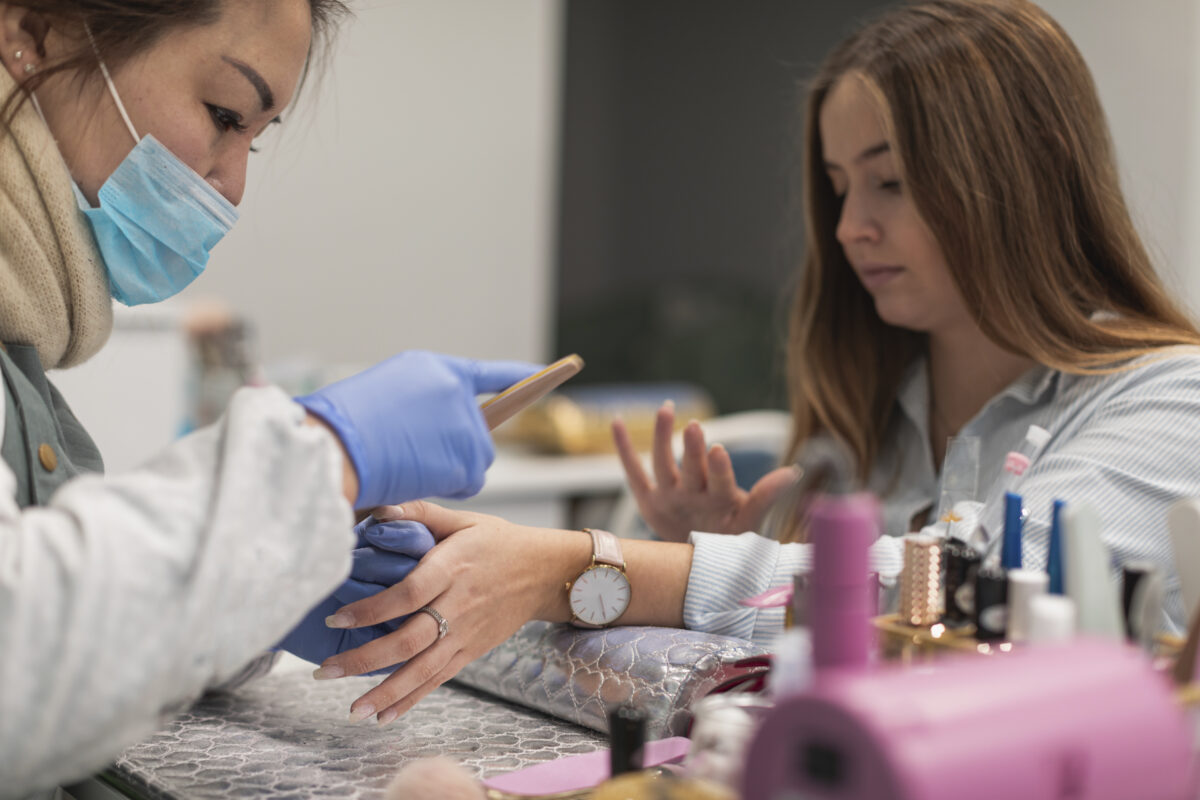 Nail Professional id doing the client's nails. Dip Powder Nails
