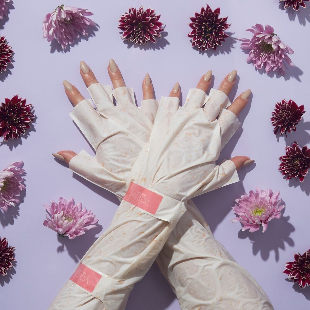 A faceless woman wearing Youth Therapy Elbow-High Gloves from Voesh