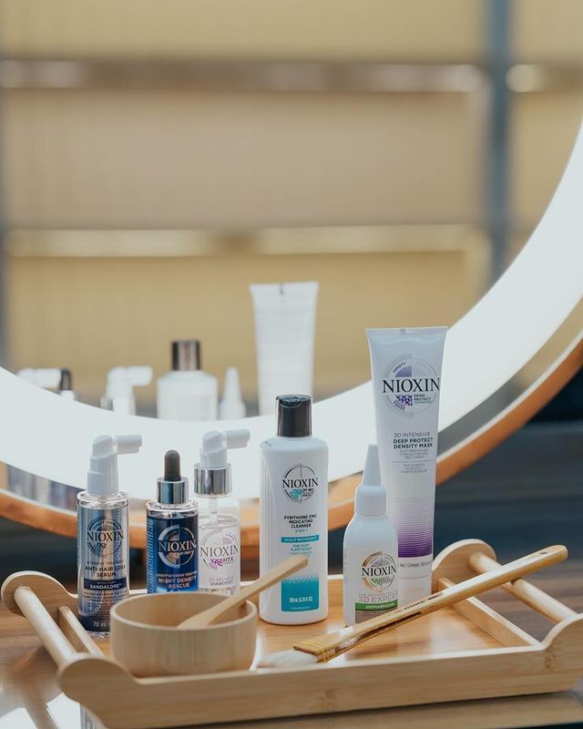 A set of Nioxin products, serum, shampoo, conditioner, and cream