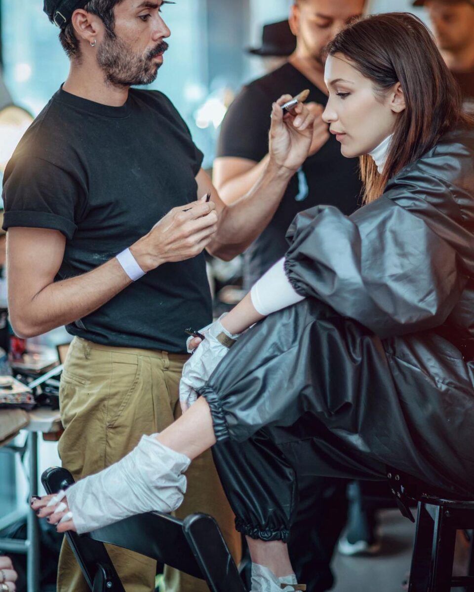 A salon professional applying a Voesh Pedi In A Box treatment to a Bella hadid feet.
