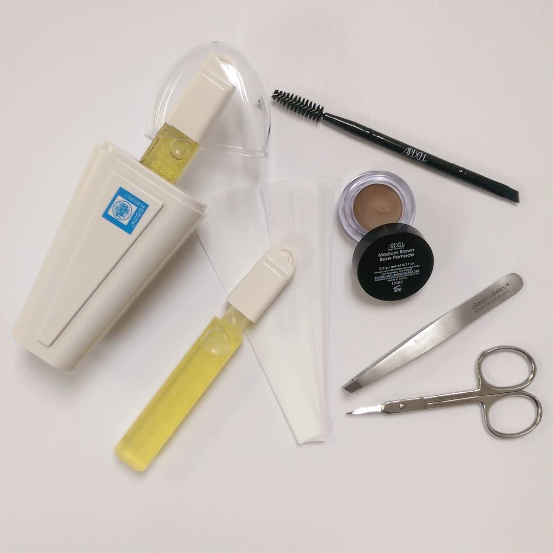 Wax accessories products from Clean & Easy on a white background: scissors, wax, eyebrow brush, and eyebrow powder.
