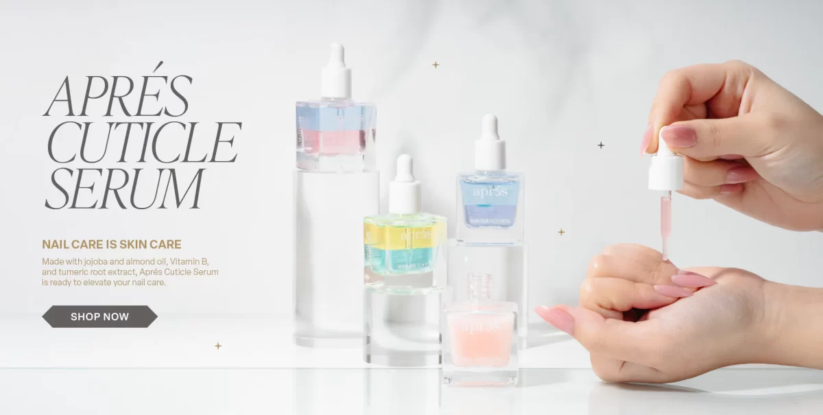 Apres new Cuticle Serum. A faceless woman hold the bottle of the The NEW Apres Cuticle Oil Serum in the WINTER RETURNS (pear, hyacinth and amber) scent.