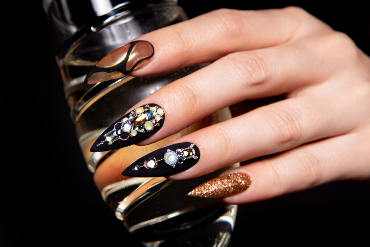 Black and gold manicure with diamonds. High-quality photo. Fall 2024 nail trends. Fall nails. Fall 2024 designs