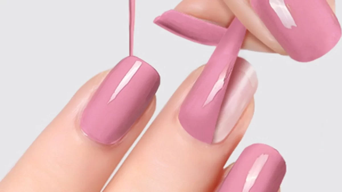 Peel-Off Base Coat. A faceless woman removing her gel polish by using Peel-Off Base Coat