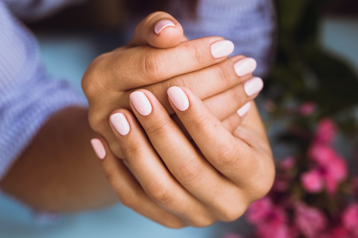 Beautiful woman's nails with beautiful pink manicure. gel polish. fall nails. 2024 nails