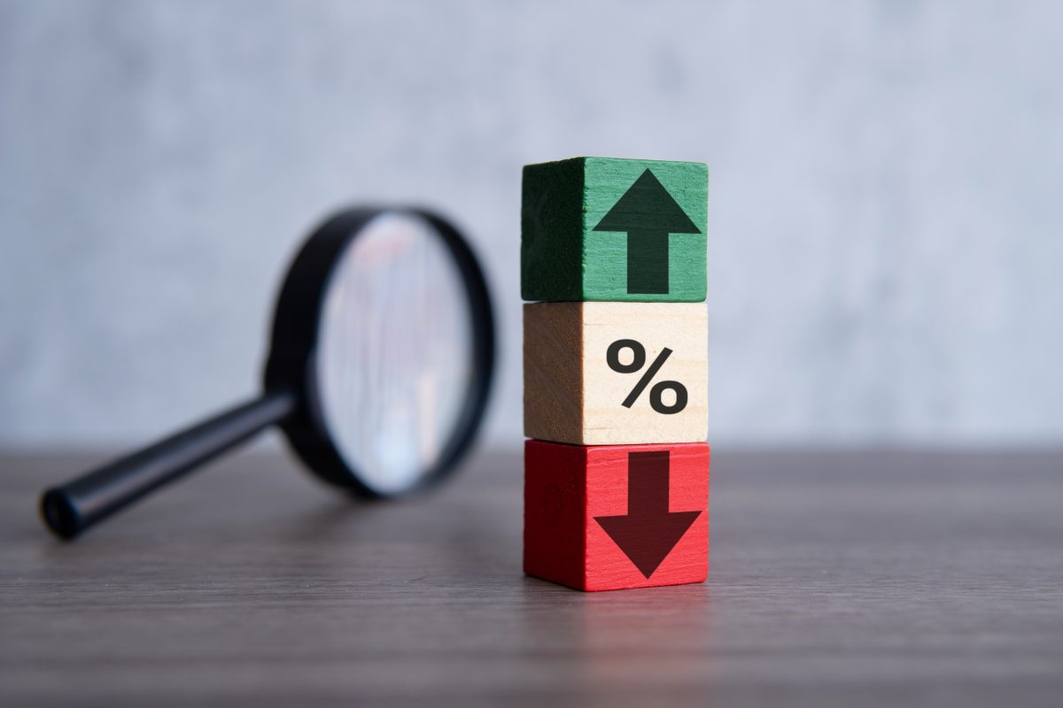Magnifying glass and wooden blocks with percentage sign, up and down icon. Interest rate, stocks and currency exchange concept. Nail salon pricing. Nail services.