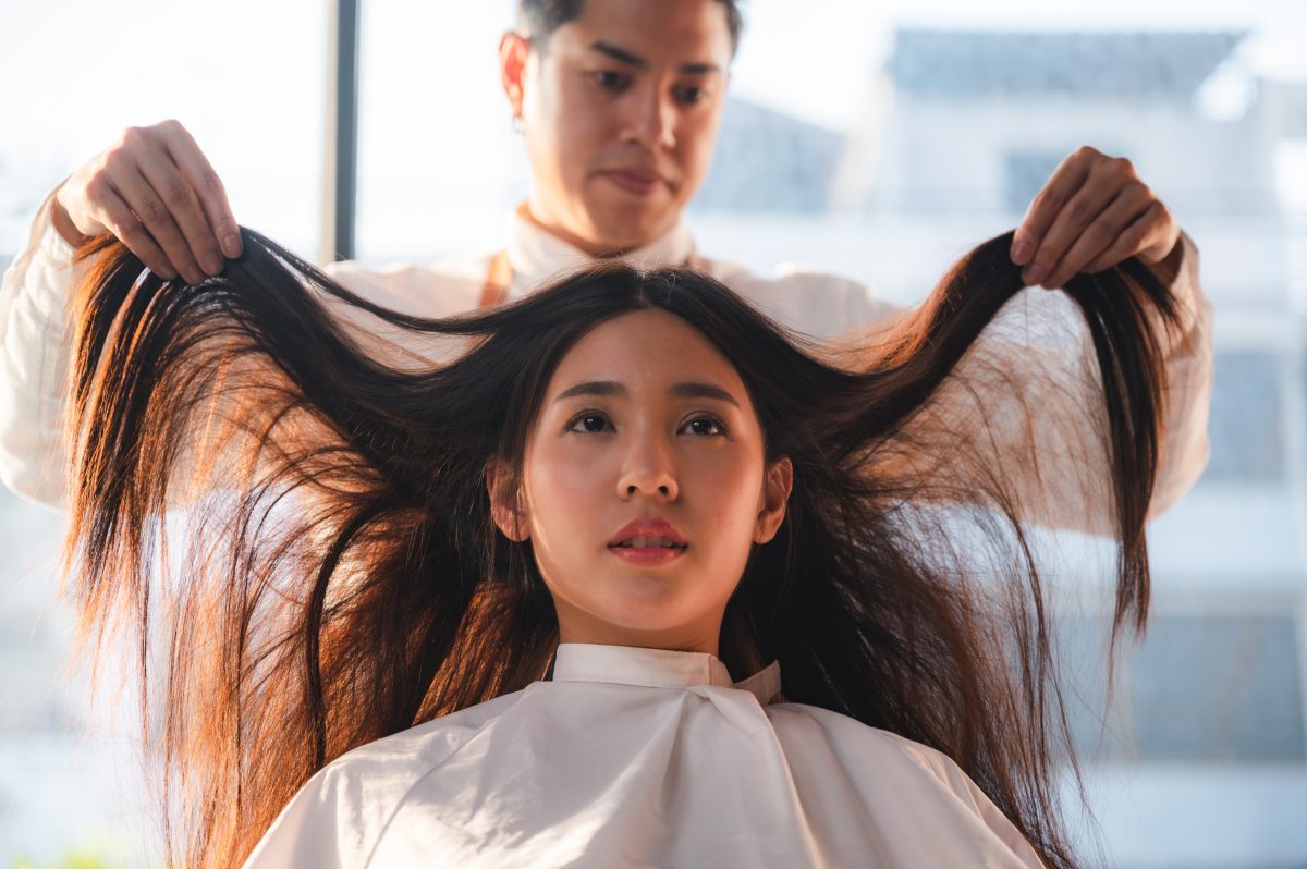 woman client person having a process to making treatment a hair with hairdresser in beauty salon