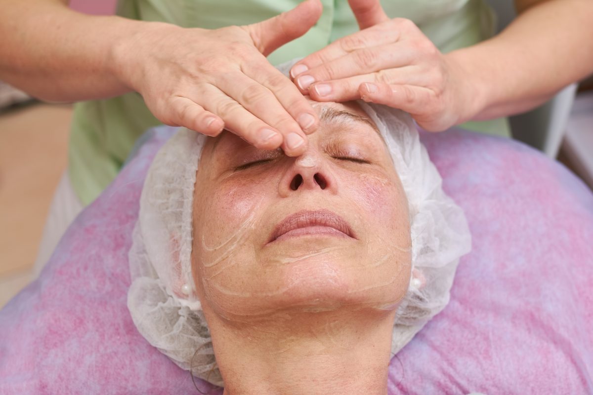 Cosmetician applying facial gel mask. Face of mature woman, cosmetology. anti-aging maks. facial hydration solution. facial care. face care. skin care.