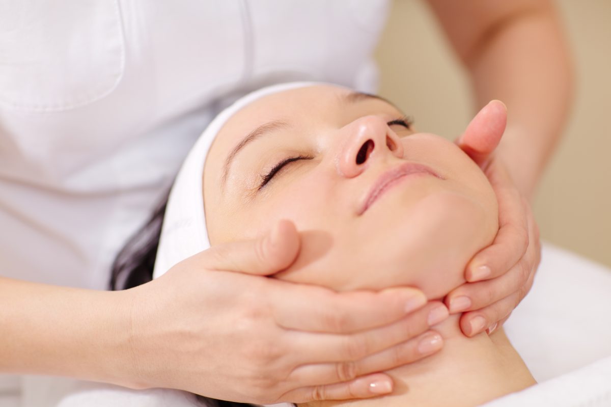 Close-up shot of a woman getting professional facial massage by therapist. facial serum. skin serum. spa care. beauty care.