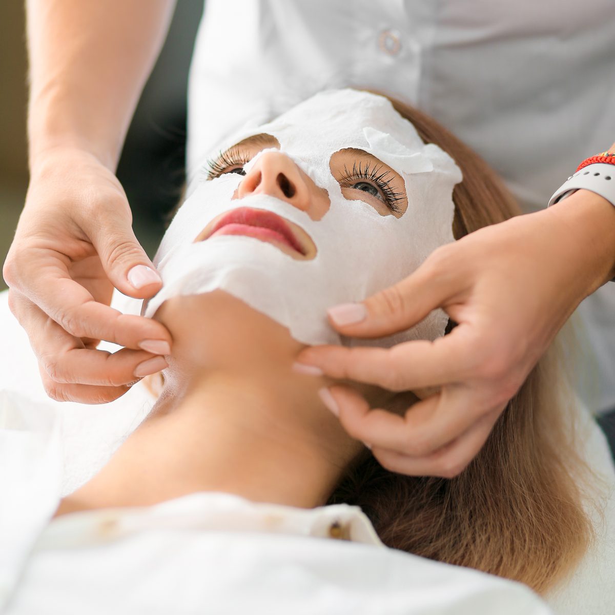 Face and body treatments. The concept of maintaining health, youth and beauty. Face masks, modern cosmetology, beautician tools, hands with gloves. Beauty techniques.