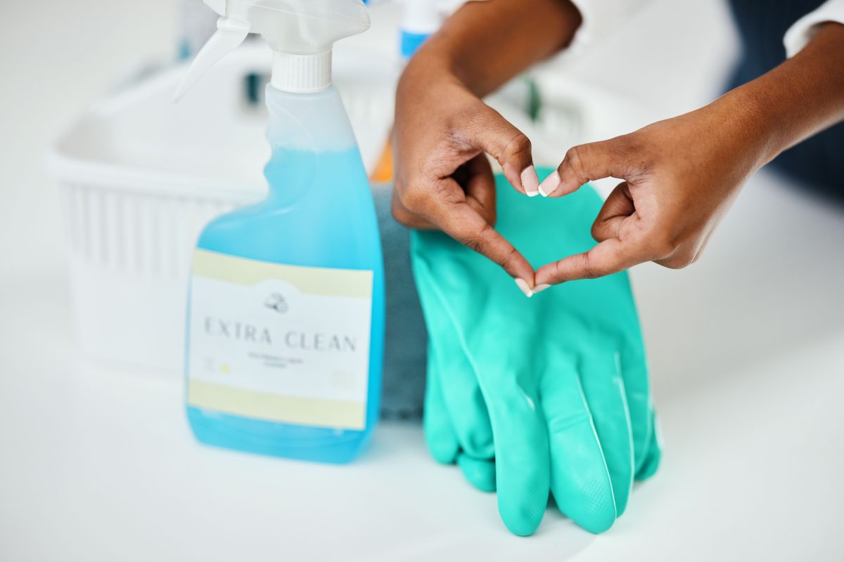 Heart hands, cleaning and chemical detergent bottle,  closeup of supplies and cleaner with hygiene. Wax cleaners. Skin Cleaners after wax. Surface wax cleaners.