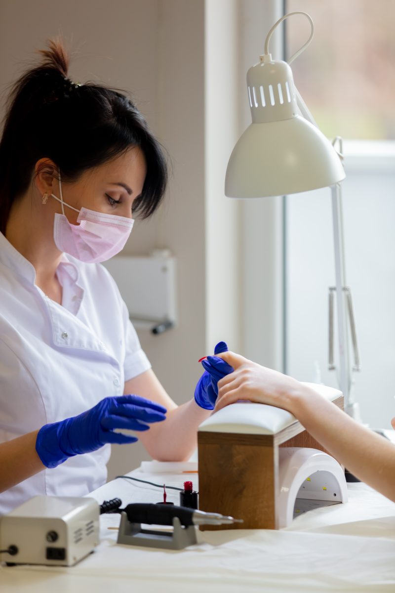 manicure master applying a nail polish. Freelance or Salon Work. Mobile nail work. Gel polish. Nail services.