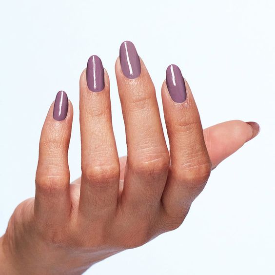 OPI Nail Lacquer - Incognito Mode. long painted nails. woman hand. woman nails. purple nails. white background.