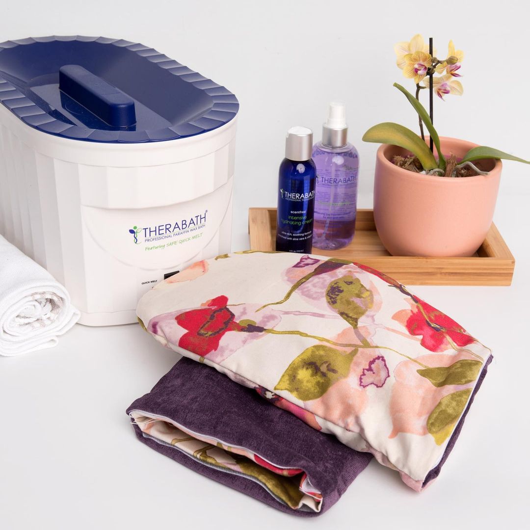 Therabath products for hand care, including hydrating cream, cleansing spray, and comfortable hand gloves, arranged together for a complete paraffin therapy experience.