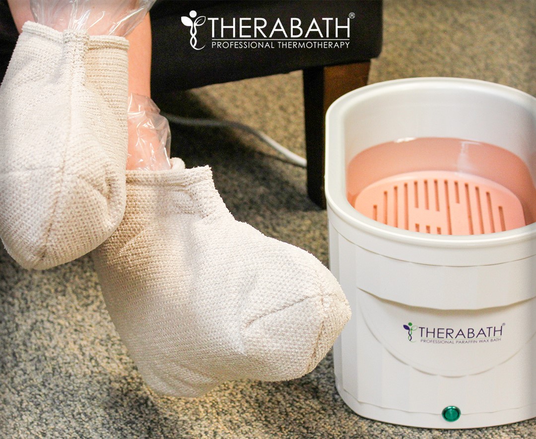 A faceless woman wearing Insulated Boots Retired Fabric after the foot paraffin bath, providing extra warmth and comfort for enhanced relaxation.