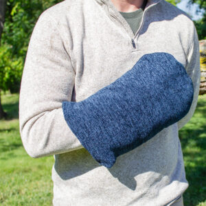 A faceless man wearing a Long Blue Comfort Heated/Cooled Mitt outside, showcasing Therabath's versatile mitt designed for both heat and cold therapy.