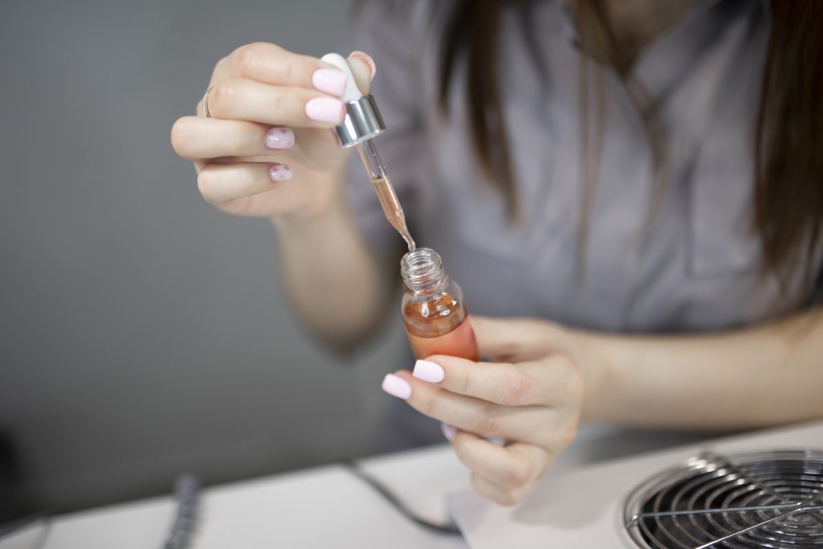 nail polish thinner. nail polish thinners. nail master doing manicure to a client in beauty spa salon. thick nail polish.