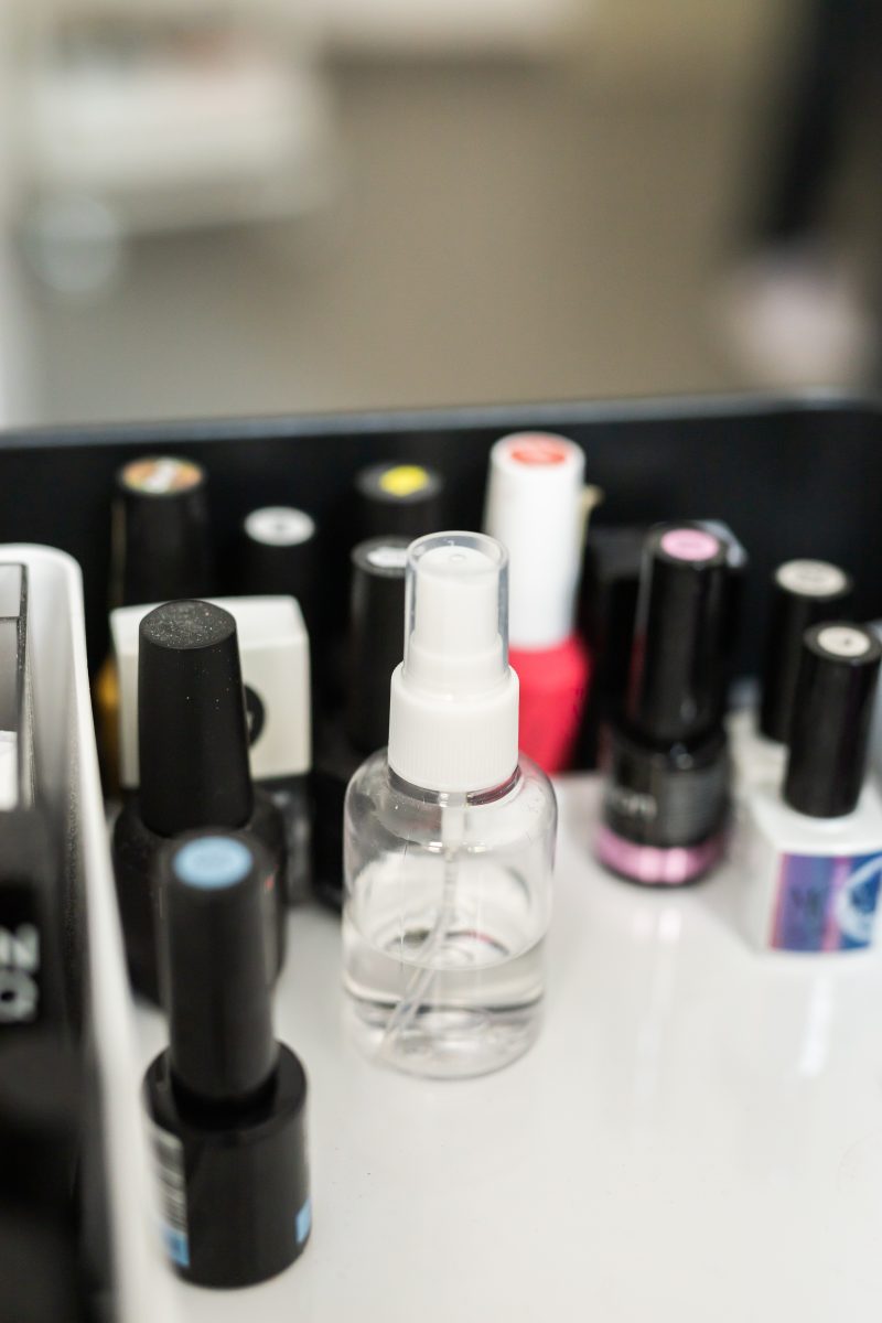 Spray nail polish thinner. Nail and cuticle care products. Cosmetic oil for softening cuticles. Nails polish on background.. nail polish bottles.