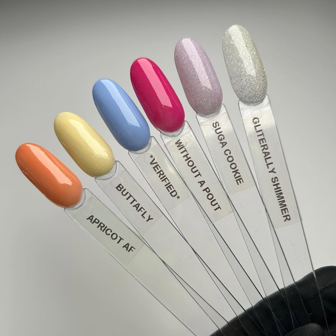 OPI Your Way Powder Perfection hues. Painted nail tips show the shades displayed on a white background:
Verified - bright blue crème
Buttafly - soft yellow shimmer
Apricot AF - bright, creamy orange
Without a Pout - hot pink crème
Suga Cookie - sheer purple glitter
Glitterally Shimmer - sparkly sheer yellow