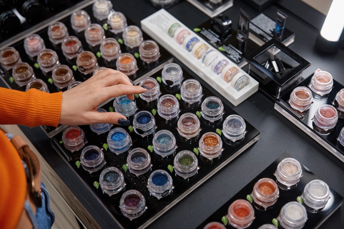 Different shades of glitter dip powder nails shade in cosmetics shop. Dip powder nails. di powder types. nails. nail enhancements.