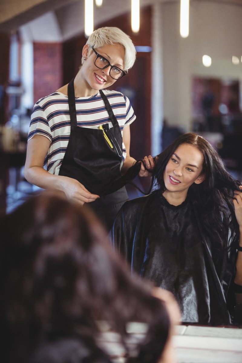 Beauty Schools in Canada. Hairdresser working on the client at the hair salon
