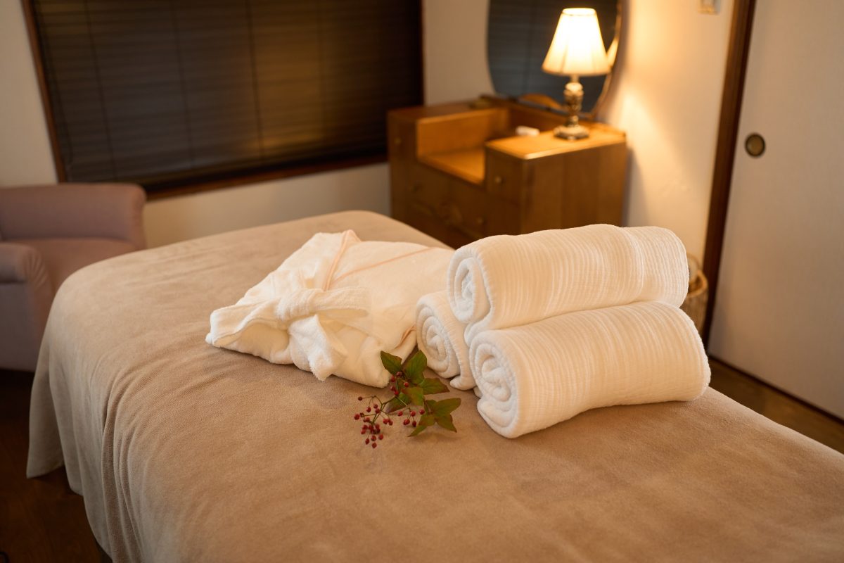 Gowns and towels on the bed in the beauty salon. Massage Towels.