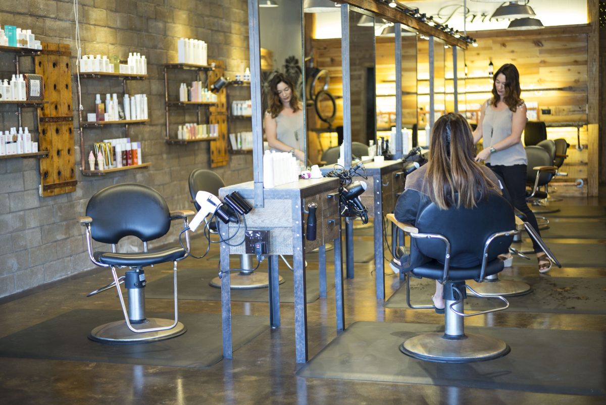 Matching Workplace Furniture. Hairstylist working in salon.