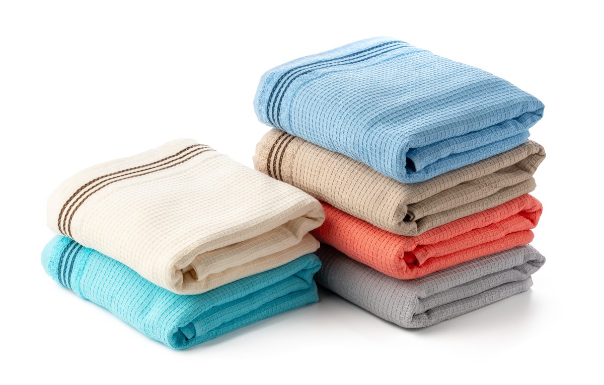 Stacked Cotton Towels isolated on White Background close up. Color and Branding Considerations
