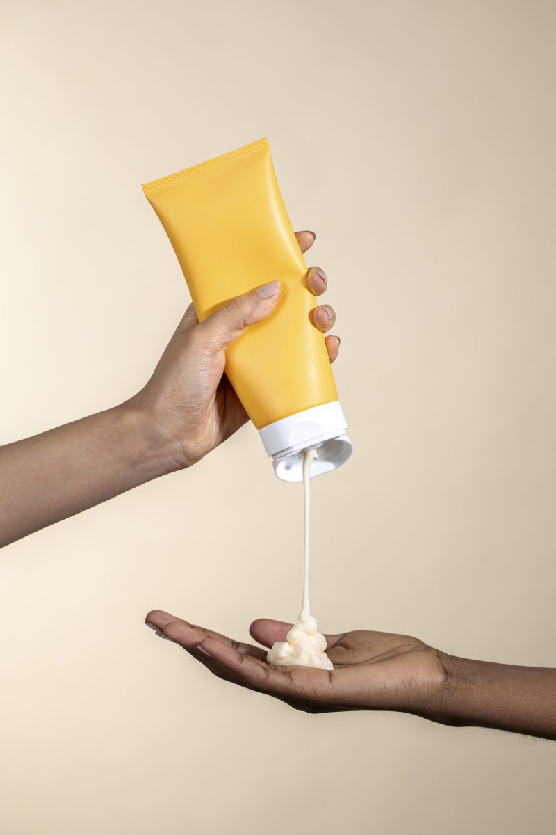 Woman squeezing cream from an unlabeled yellow tube. What Are Lotions?