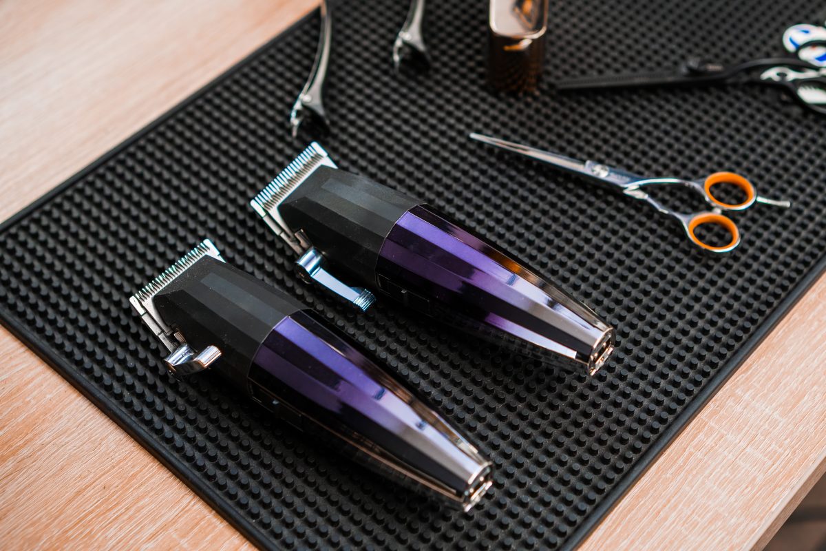 Trimmers, clippers and scissors on the table in the barbershop.