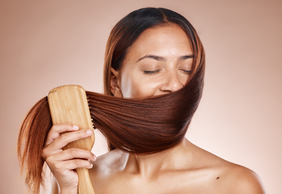 Hair care, beauty and brush of a woman brushing after a salon, hairdresser or shampoo treatment.