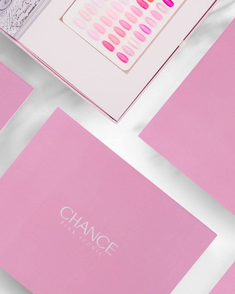 The open Chance "Pink Iconic" Gel Collection display box on a white surface. The elegant lid features a 3D pop-up illustration of the Eiffel Tower and a stylish Parisian street scene. The pink box base holds the 48-shade swatch board (partially visible), symbolizing a complete, curated collection for iconic pink nail designs.